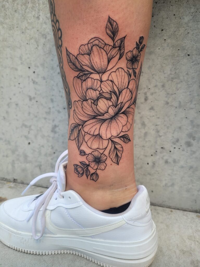 Floral tattoo voor Suus met bloemenmotief, gezet bij Tat2holics in Den Haa